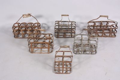 six small metal baskets with handles and handles on a white surface