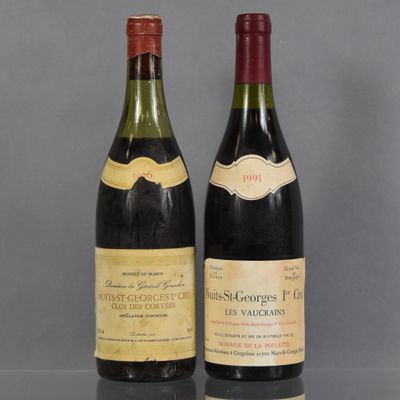 two bottles of wine sitting on top of a table next to each other