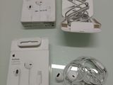 a box of ear buds and a pair of headphones on a table