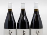 trois bouteilles de vin posées sur une table l'une à côté de l'autre