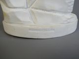 a close up of a pair of white sneakers on a table