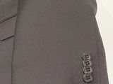 grey suit with buttons on the lapel of a man ' s jacket