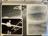 a black and white photo of a man flying a plane