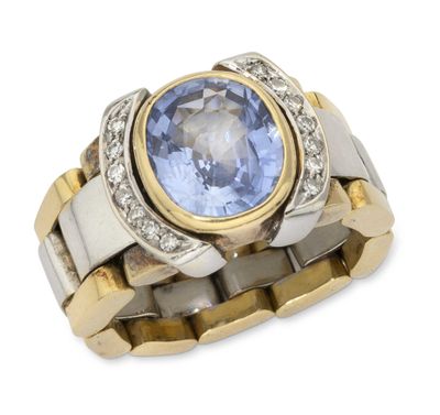 an image of a ring with a tanzane stone surrounded by diamonds