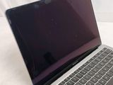 a laptop computer that is sitting on a white surface