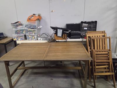 several chairs and a table in a room with a lot of clutter