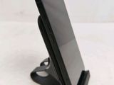 a cell phone that is sitting on top of a stand