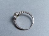 a silver ring with a diamond in it on a table