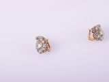 a pair of diamond earrings on a white background