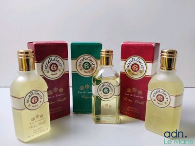four different bottles of perfume sitting next to each other on a table