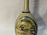 a small vase with a dragon on it sitting on a table