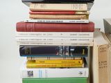many books stacked on top of each other on a table