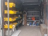 the back of a van with a bunch of tools in the back
