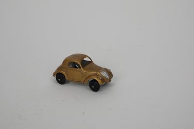 a small toy car that is sitting on a white surface