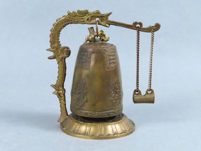 a brass bell with a chain hanging from it ' s neck