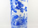 a blue and white vase with birds and flowers on it
