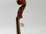 a close up of a violin on a stand against a white background