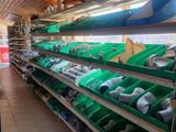 many shelves of different types of shoes in the store