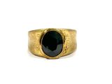 a close up of a gold ring with a black stone
