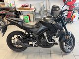 a black motorcycle that is parked in a garage