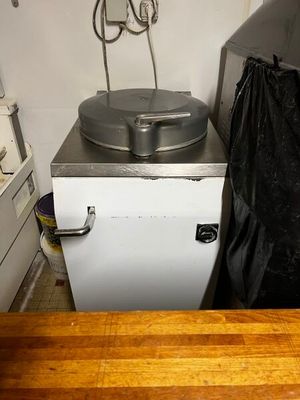 une image d'une cuisine avec une cuisinière et une poubelle