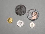 several coins and a coin with a picture of a man on it