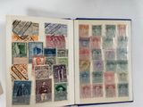 an open book with stamps on it on a table