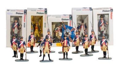 six figurines of soldiers in uniform standing in front of a box
