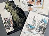 trois albums de bandes dessinées posés sur une table, avec le dessin d'un homme et d'une femme