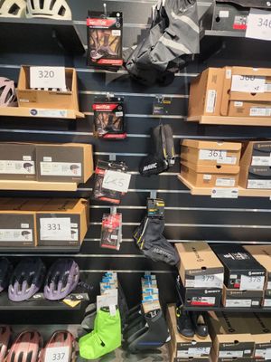 many pairs of shoes on the shelves in the store