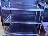 a metal cart with three shelves on it