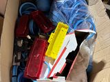 a cardboard box filled with assorted items on the ground