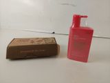 a bottle of lotion and a box of soap on a table