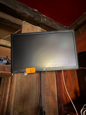 a flat screen tv hanging on a wall in a room