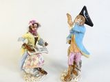 two figurines of a man and a woman on a scooter