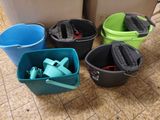four buckets that are sitting on the floor next to each other