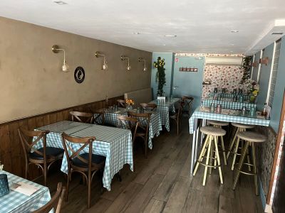 tables and chairs in a restaurant with blue and white checkered tablecloths