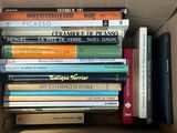 a box full of books that are sitting on top of each other
