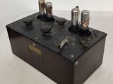 an old fashioned electronic device sitting on top of a white table