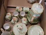 a box full of tea and coffee cups and saucers