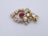 an image of a gold and diamond eye broochle