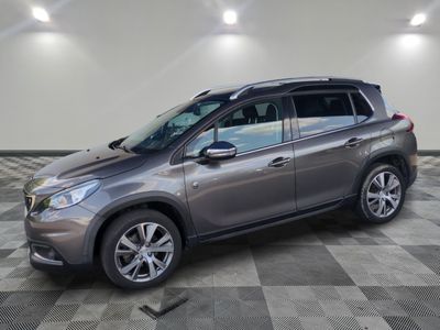 a grey car parked in a garage with a checkered floor
