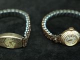 pair of silver and gold rings on a black background