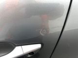 a close up of a car door handle with a sticker on it