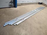 a set of four stainless steel bars sitting on the ground