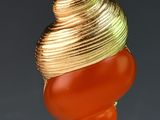 a gold and red shell hanging from a wire