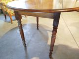 a wooden table with a glass top in a room