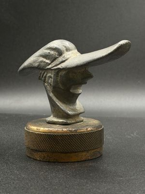 a close up of a statue of a woman wearing a hat