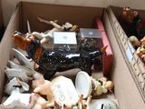 a box full of assorted figurines sitting on the floor