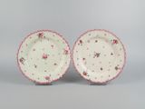 pair of pink and white plates with floral designs on them